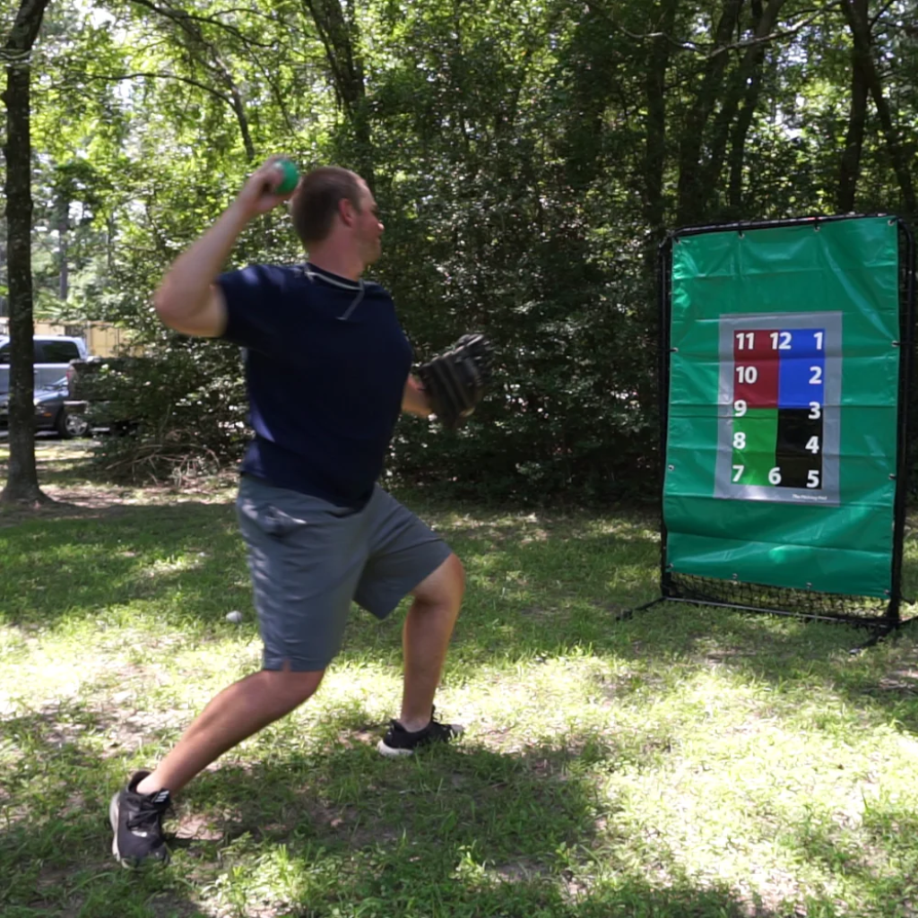 Athlete preparing to release an 8oz weighted baseball toward a target, focusing on arm health, strength development, and increased throwing velocity.