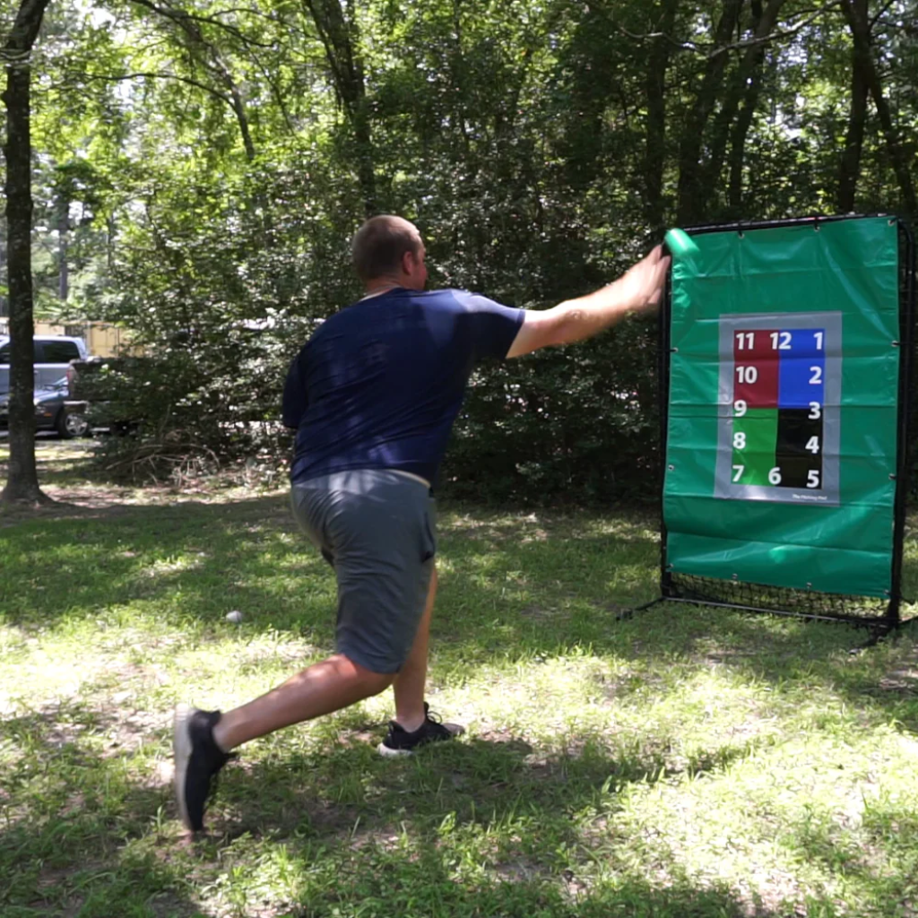 Athlete releases an 8oz weighted baseball toward a target, focusing on arm health, strength development, and increased throwing velocity.