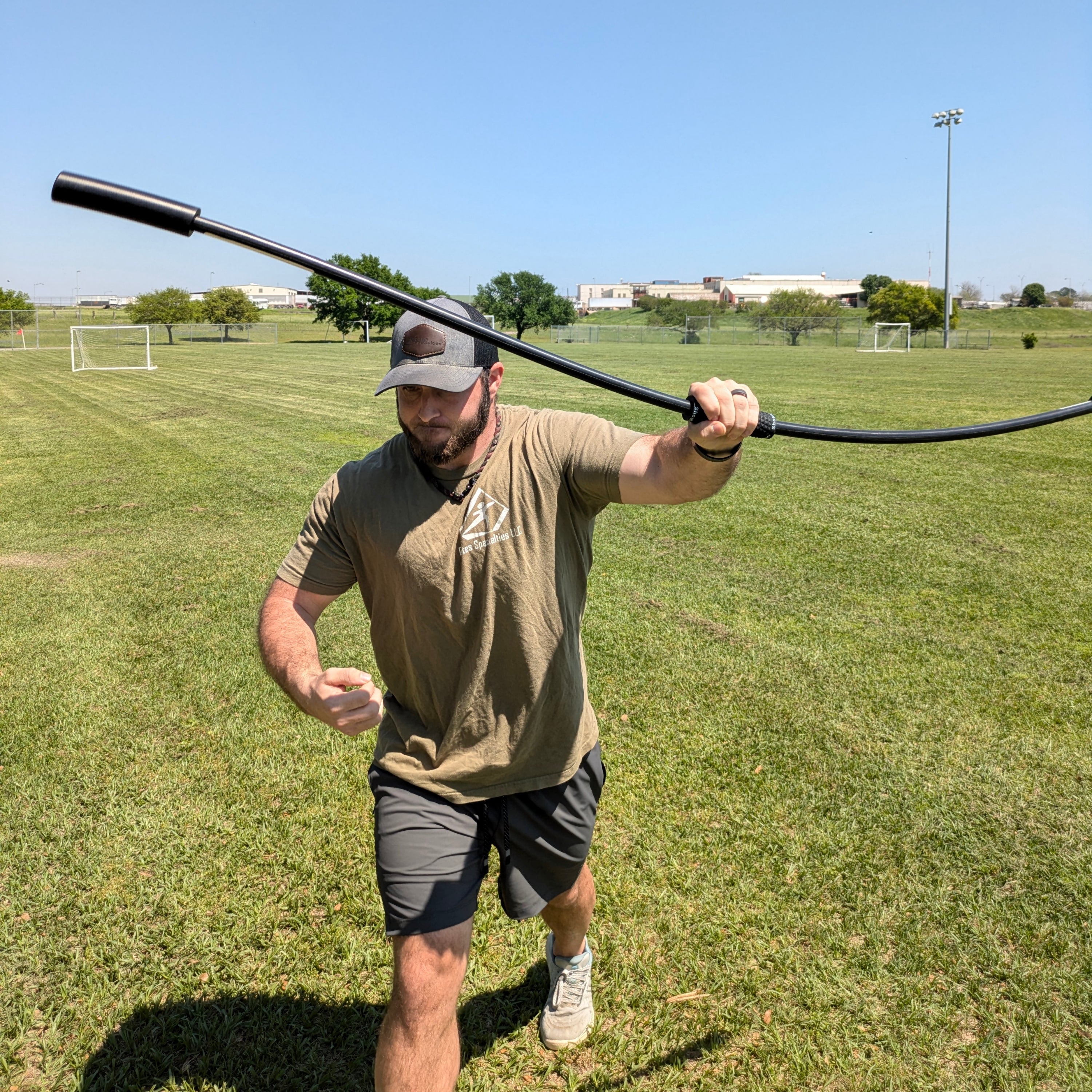 The athlete employs the TAP® Shoulder Tube in a pitching-specific warm-up, extending his arms as if releasing a ball and inducing chaotic oscillations around his grip to dynamically prepare the arm and shoulder for throwing.