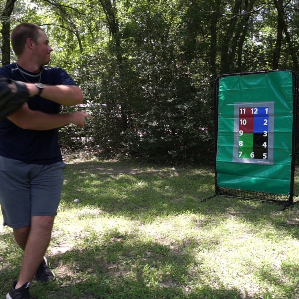 Athlete preparing to throw a weighted baseball into a target.