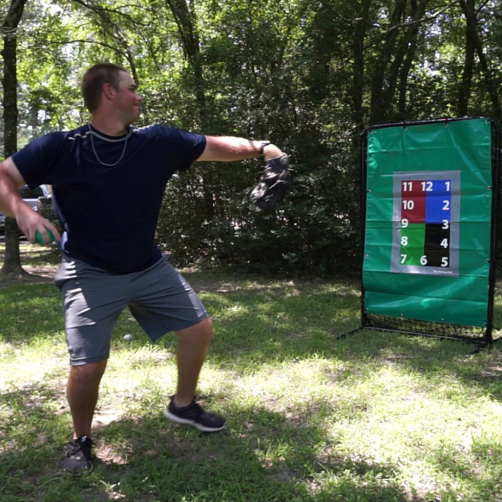 Athlete preparing to throw an 8oz weighted baseball toward a target, focusing on arm health, strength development, and increased throwing velocity.