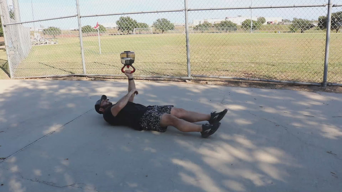 Video demonstrating KHAOS® Waterbell exercises, showcasing dynamic resistance training. Athletes perform bottom-up carries, Turkish get-ups, and shoulder stability drills as water shifts inside, creating an unstable load for enhanced control and strength.