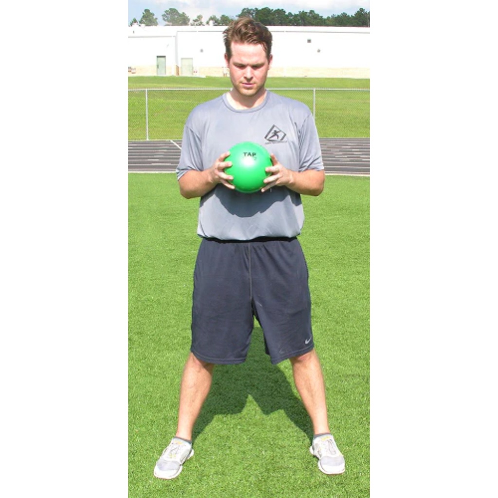 A pair of hands grips a green pummel ball, ready to be slammed.