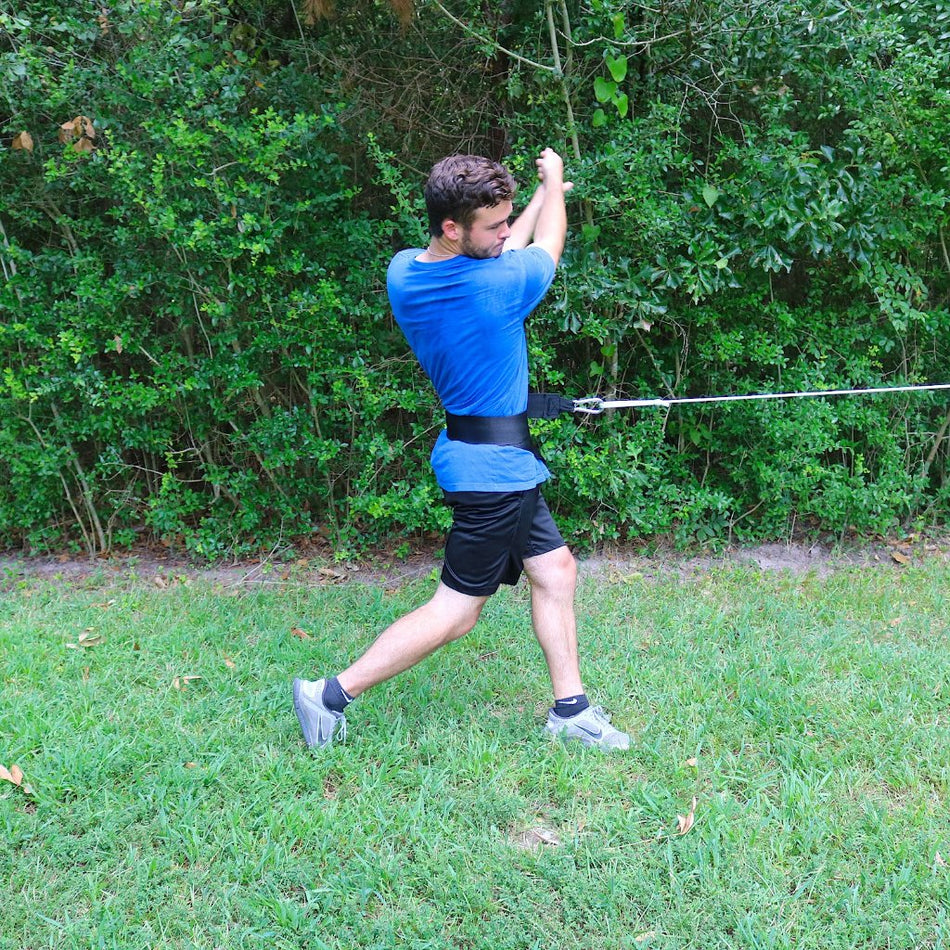 Donley Hip Spin attached to the athletes hip. It is resisting hip rotation while an athlete swings or pitches.
