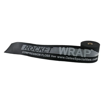 Black Rocket Wrap Compression Floss coiled neatly on a clean surface, showcasing its Standard resistance level and durable natural latex construction.