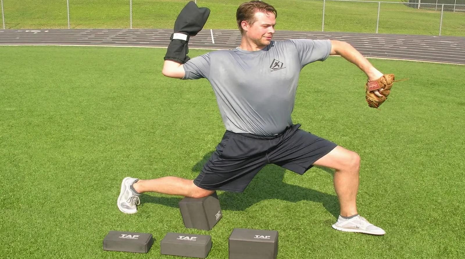 Baseball pitcher training with the TAP® Kneeling Block and a Training Sock in arm-cock throwing position.