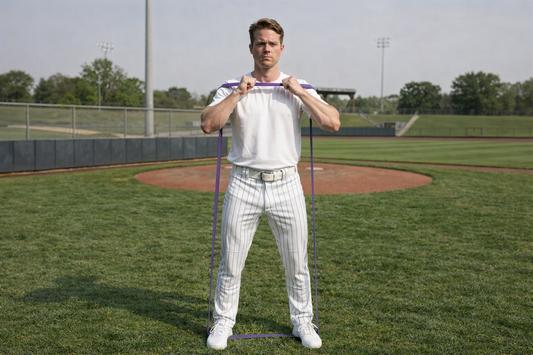 Baseball player performing squats with the Giant Flat Band.