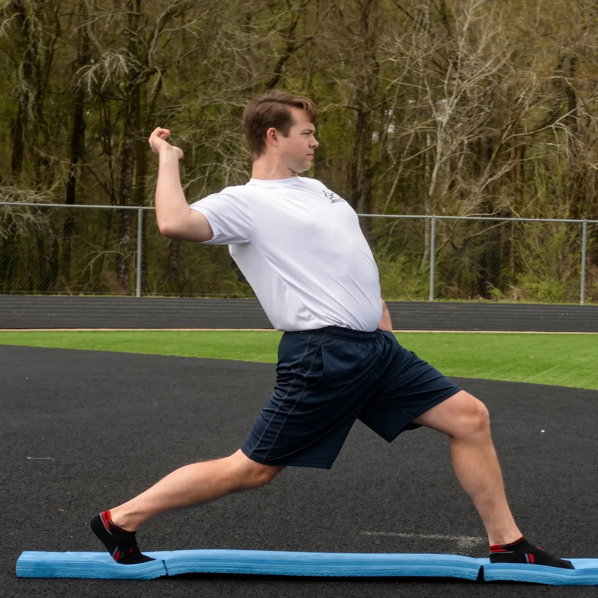 Athlete performing the arm layback phase on the Folding Balance Beam, utilizing a narrowed unstable variable stimulus for lead-side stabilization and kinetic chain organization.