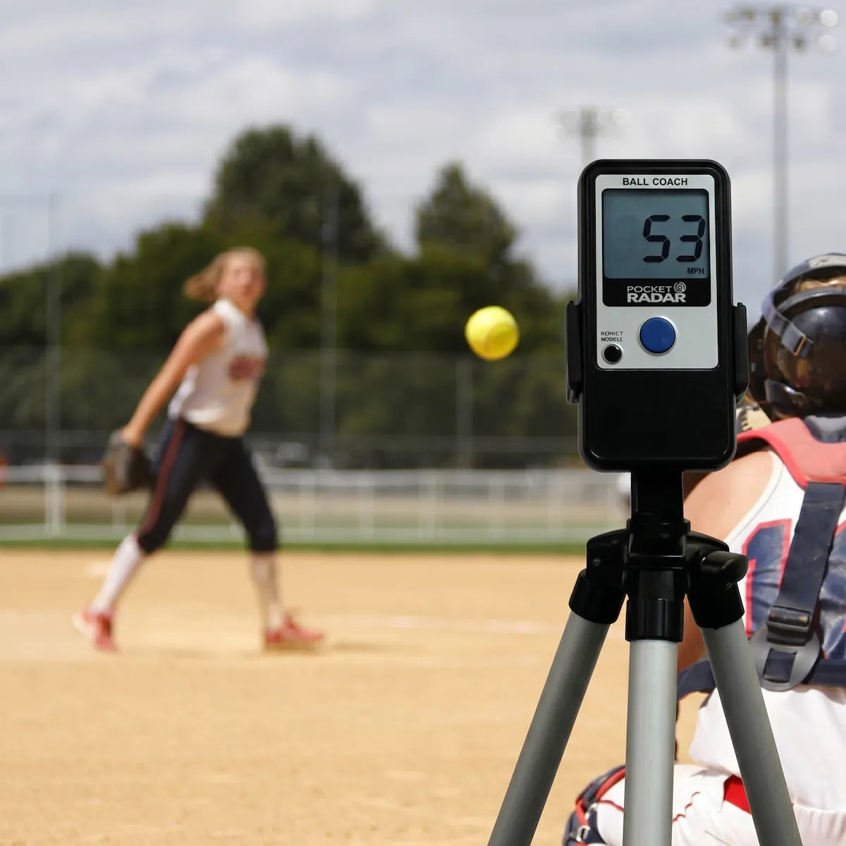 Ball Coach™ radar gun tracking the speed of a softball pitch during training—ideal for coaches and athletes focused on velocity improvement