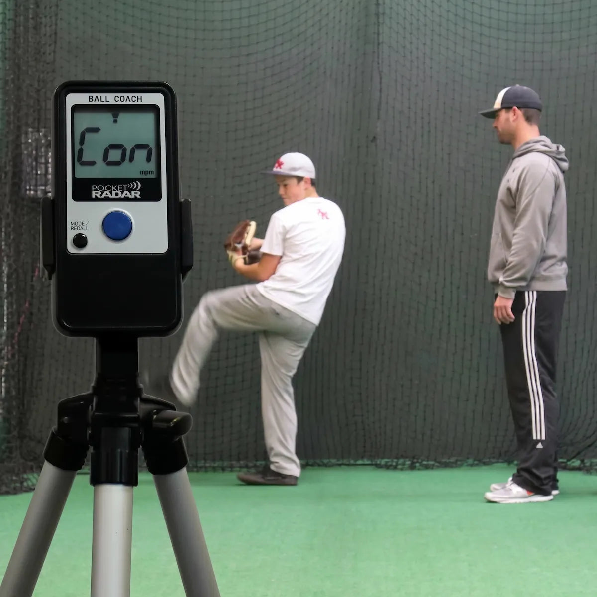 Ball Coach™ radar gun mounted on a tripod stand for hands-free velocity tracking during baseball or softball training sessions.
