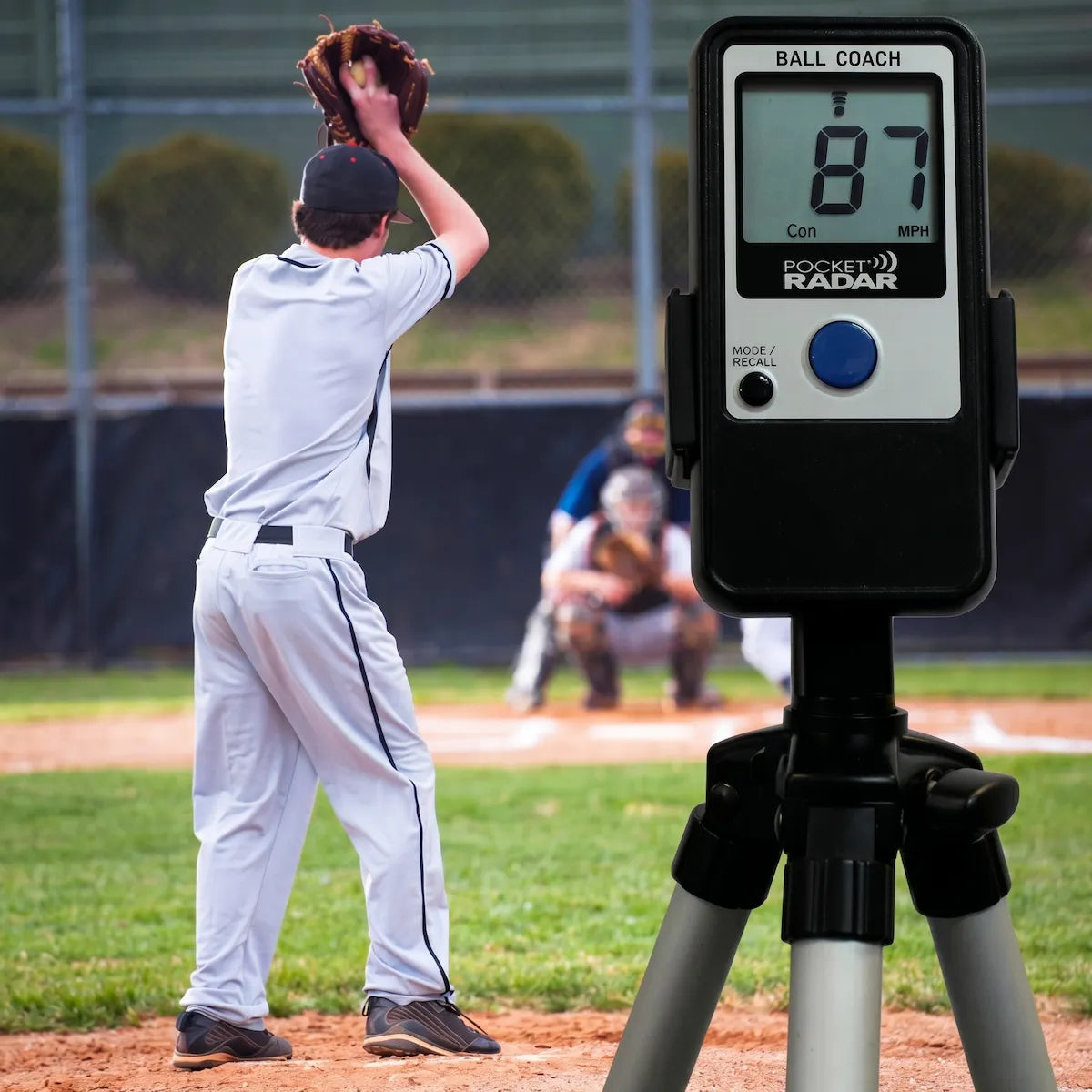 Ball Coach™ radar gun measuring the velocity of an incoming baseball pitch—providing real-time data for training and game analysis.