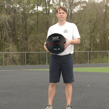 Soft Medicine Ball 16lb being held in both hands to demonstrate the size of the ball.