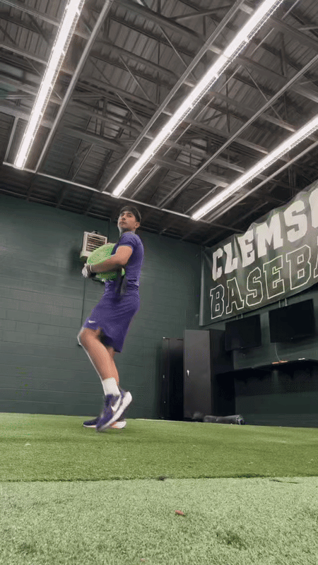 Baseball pitcher training with the KHAOS® Bulgarian Water Bag, utilizing shifting water resistance to activate core stabilizers, build strength, and refine pitching mechanics for optimal performance.