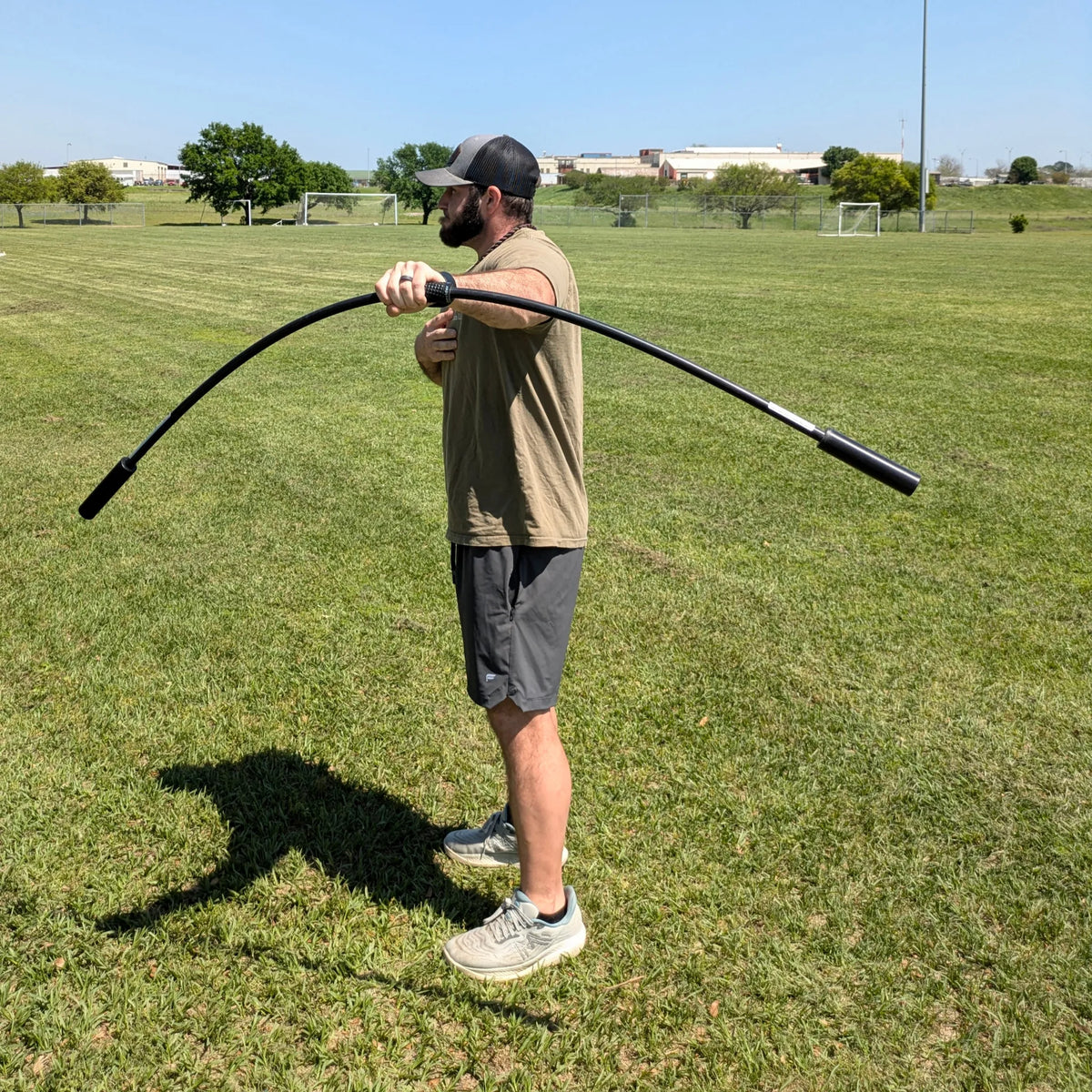 Athlete using a pronated grip to drive vertical oscillations with the TAP® Shoulder Tube. This rhythmic stabilization drill creates high-frequency perturbations that engage the anterior deltoid and serratus anterior, building a stable foundation for the arm and shoulder complex.