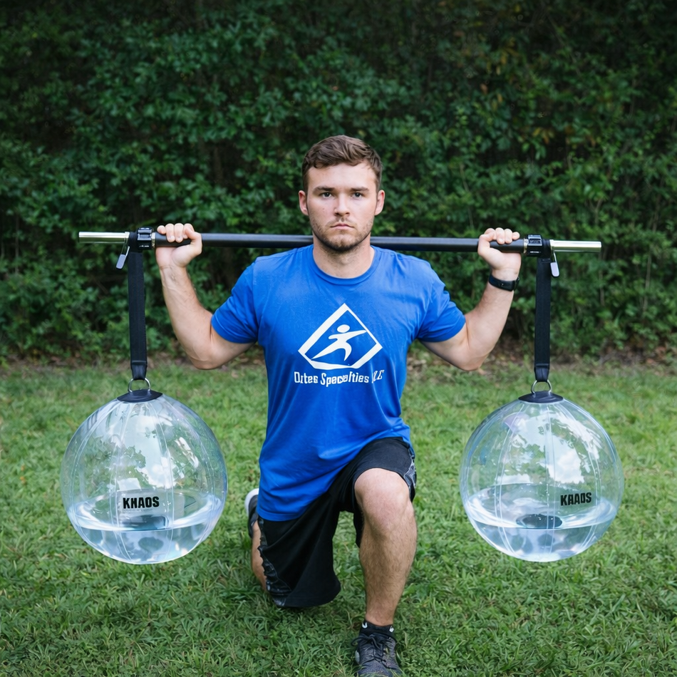 Athlete performing a lunge with the Khaos® Yoke, featuring two partially filled water balls suspended by straps from a bar, creating dynamic instability to engage core, knee, and hip stabilizers during functional training.