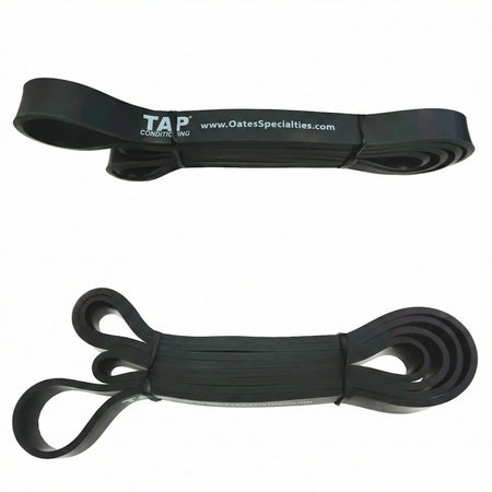 Black TAP® Giant Flat Band, a heavy 1/2” 41-inch loop serving as the standard resistance baseline for junior high and high school athletes training lumbopelvic stability and thoracic rotation.