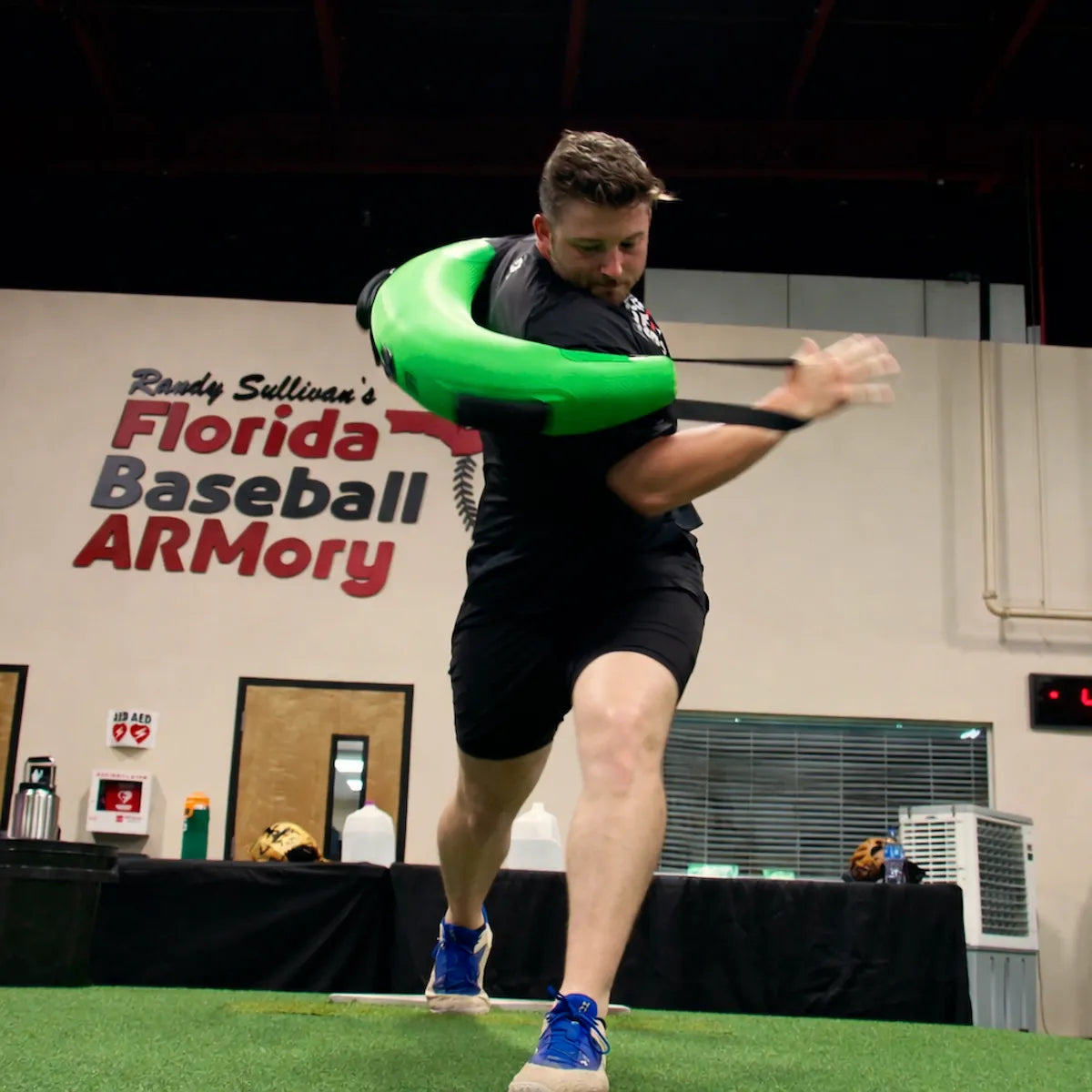 Athlete at the Florida Baseball ARMory training with the KHAOS® Bulgarian Water Bag, utilizing unstable water resistance to build rotational power and throwing arm stability.