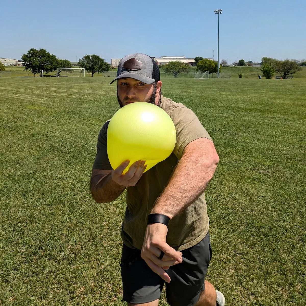 Athlete using the TAP® Connection Ball® as a tactile reference against the lead-side cheek to help maintain head stability and consistent torso-arm connection during the throwing motion.