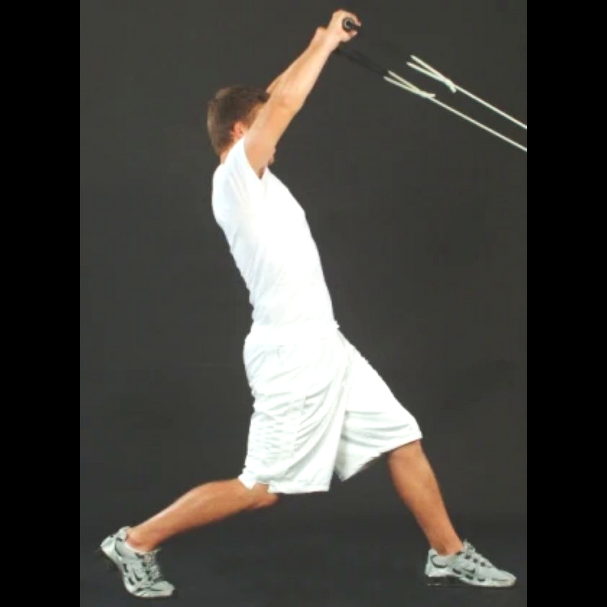Dynamic Arm Tubing being pulled above the head to improve strength of shoulders.
