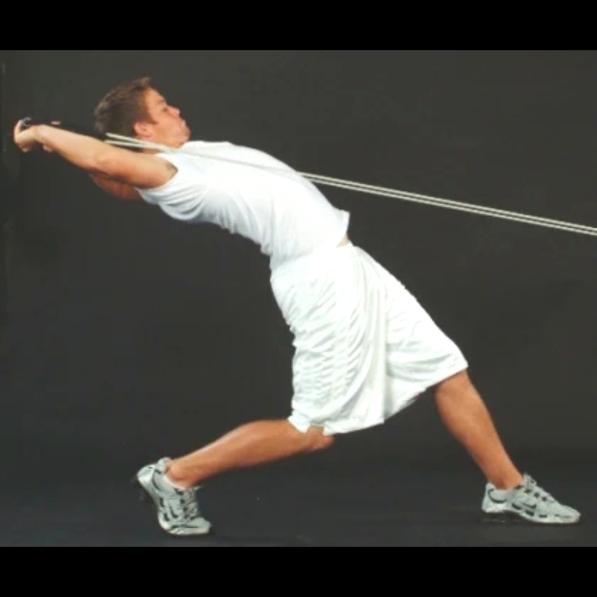 Athlete performing full-extension pull with Dynamic Arm Tubing to build torso strength and enhance flexibility.