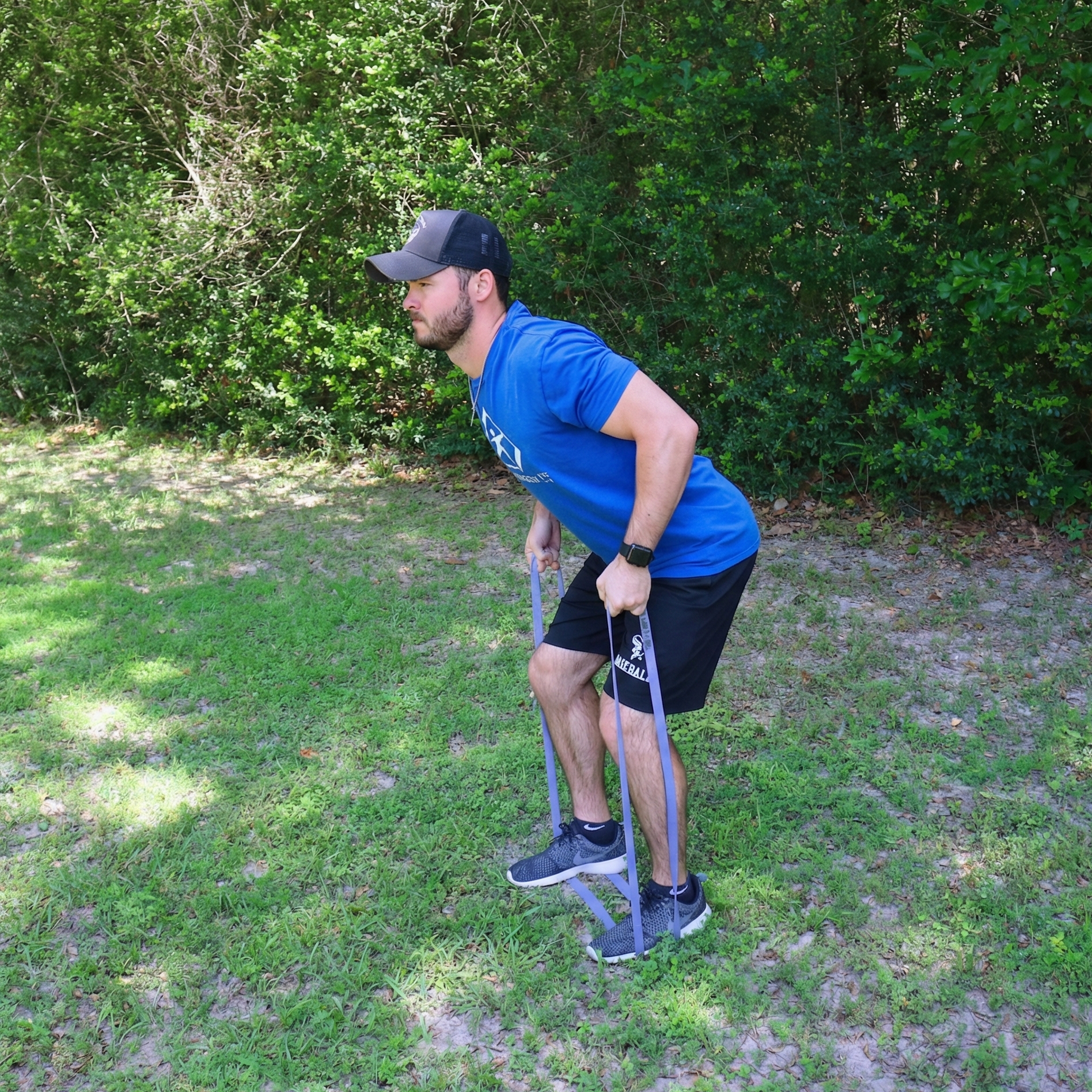 An athlete performing a bent-over row utilizing a Purple (Medium) TAP® Giant Flat Band. This hinge-position exercise emphasizes scapular retraction and the stability of the posterior rotator cuff. The accommodating resistance of the 41-inch loop challenges the athlete to maintain a neutral spine and trunk organization while the shoulder blades move through a full range of motion, providing a vital counter-balance to forward-dominant throwing patterns.