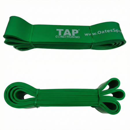 A Green (Super Heavy - 1 3/4") TAP® Giant Flat Band. This 41-inch continuous loop provides high-magnitude accommodating resistance, specifically calibrated for mature collegiate and professional athletes. It is utilized for high-output drills such as resisted sprints and heavy hinge patterns, challenging the athlete’s global structural integrity and ability to manage significant counter-rotational forces.
