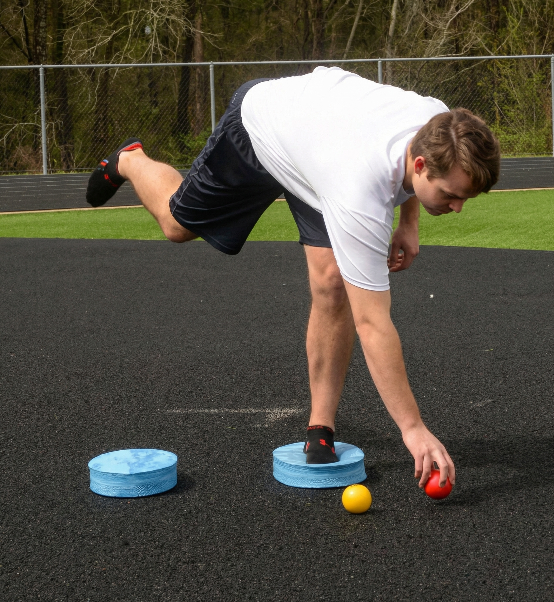 Athlete utilizing an Oval Balance Pad for lead-side stabilization and kinetic chain organization, creating an unstable variable stimulus for increased power.