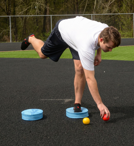 Athlete utilizing an Oval Balance Pad for lead-side stabilization and kinetic chain organization, creating an unstable variable stimulus for increased power.