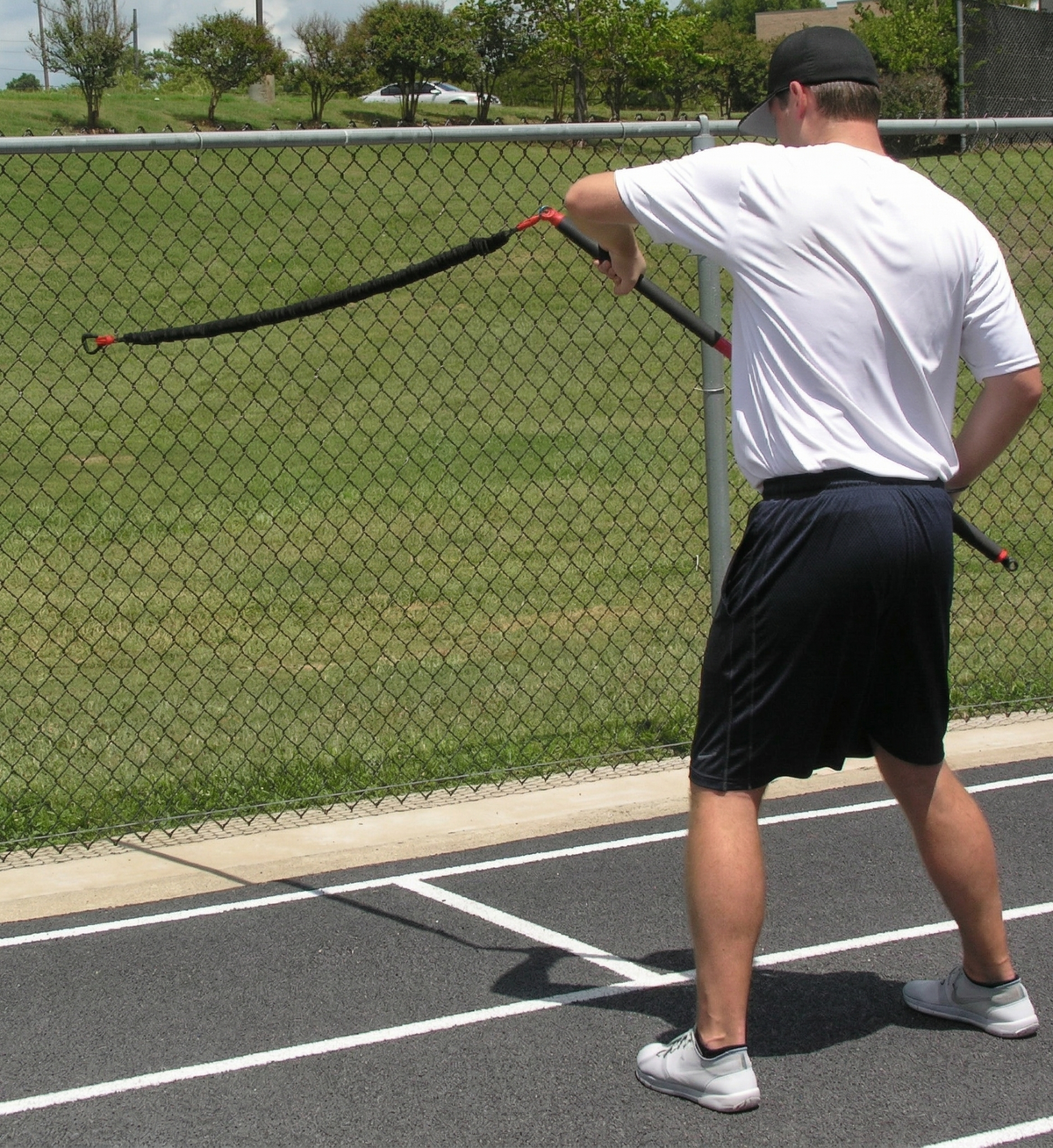Athlete performing resisted rows with the KHAOS Pivoter, utilizing elastic rhythmic perturbations to drive lead-side stabilization and kinetic chain organization for increased power.