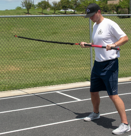 Athlete preparing for a dynamic resistance drill with the KHAOS Pivoter, establishing lead-side stabilization and kinetic chain organization for increased power.