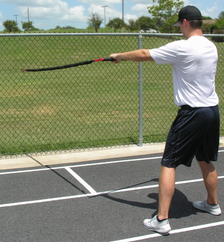 Athlete performing a one-sided resisted chest pull with the KHAOS Pivoter, utilizing elastic rhythmic perturbations to drive lead-side stabilization and kinetic chain organization for increased power.