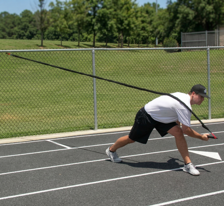 Athlete performing a full-body chop with the KHAOS Pivoter, utilizing elastic rhythmic perturbations to drive lead-side stabilization and kinetic chain organization for increased power.