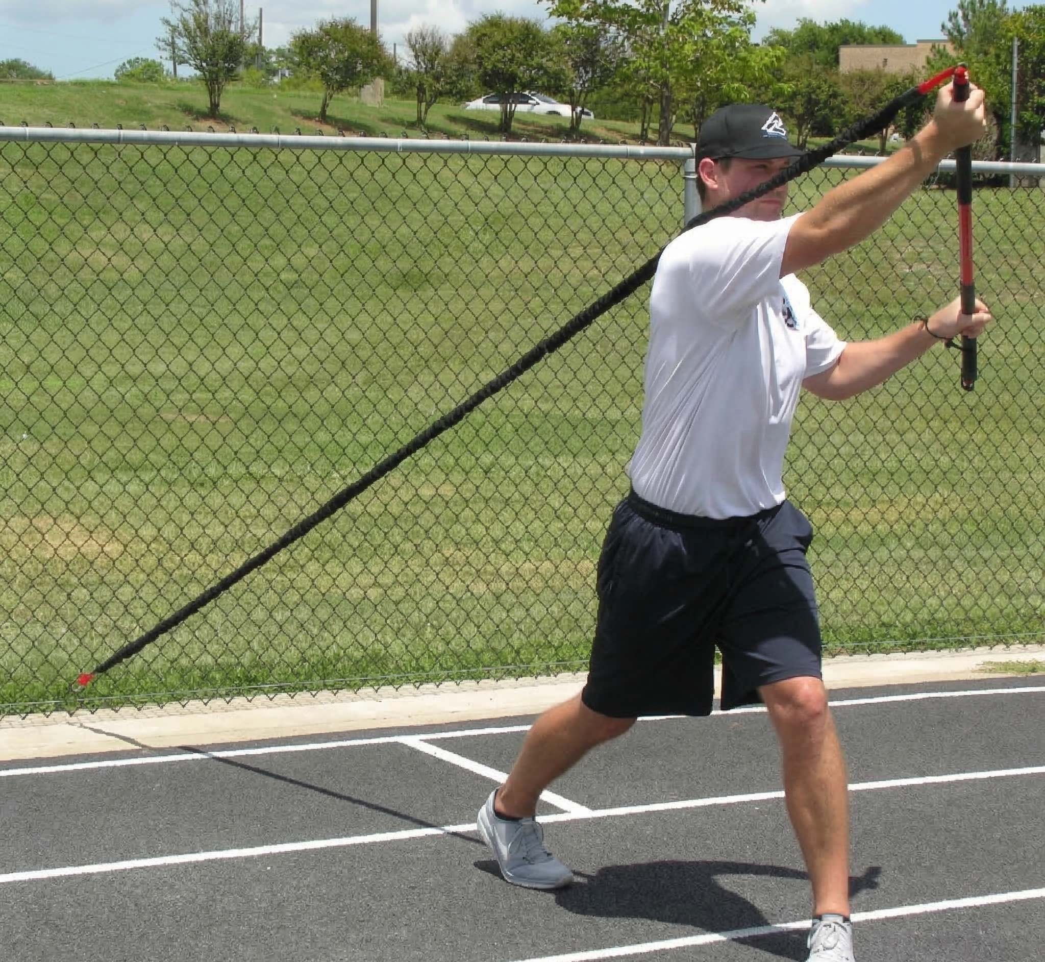 Athlete performing an upward crossbody chop with the KHAOS Pivoter, utilizing elastic rhythmic perturbations to drive lead-side stabilization and kinetic chain organization for increased power.