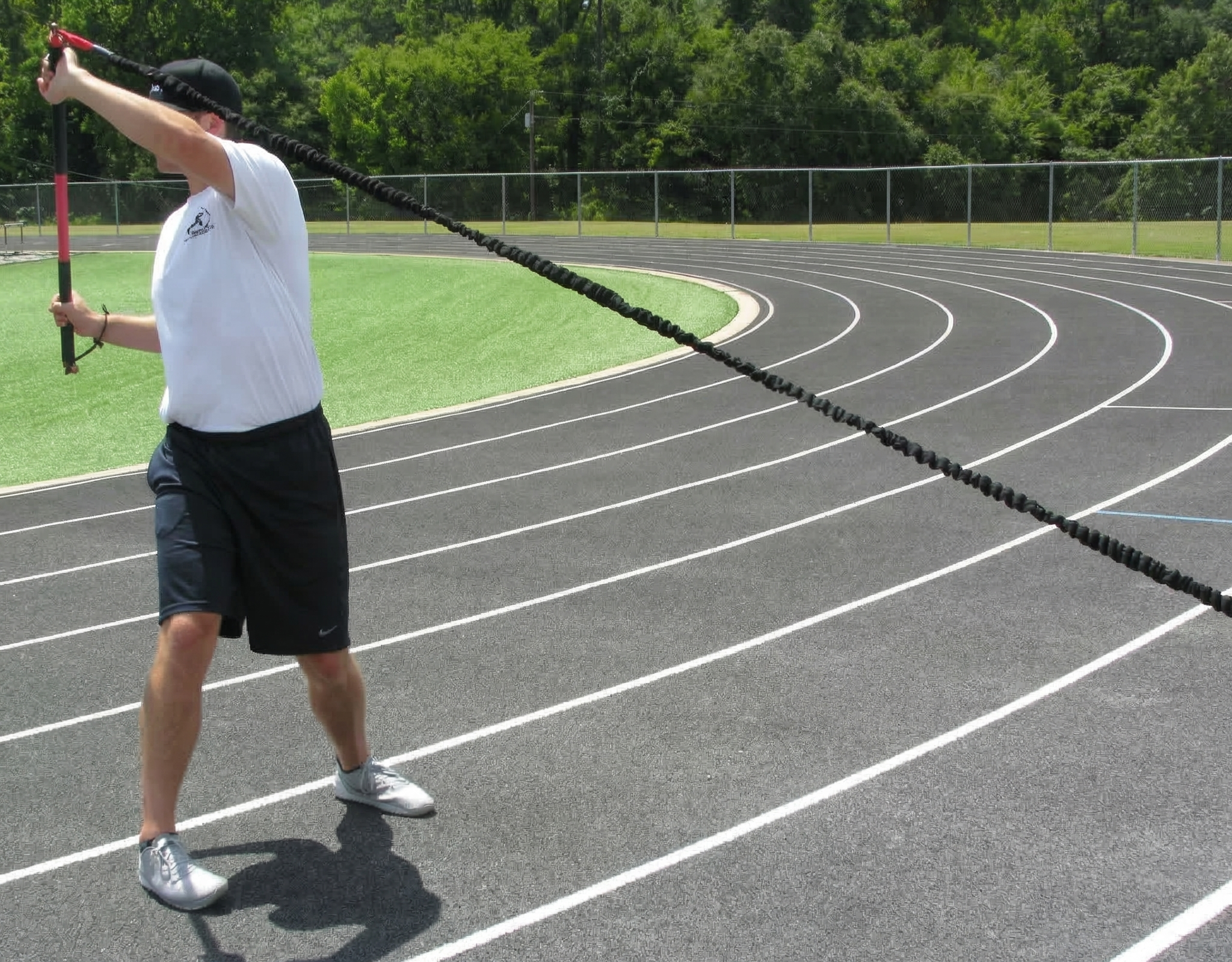Athlete performing an upward crossbody rotation, utilizing lead-side stabilization and kinetic chain organization to drive increased power through the throwing arm.