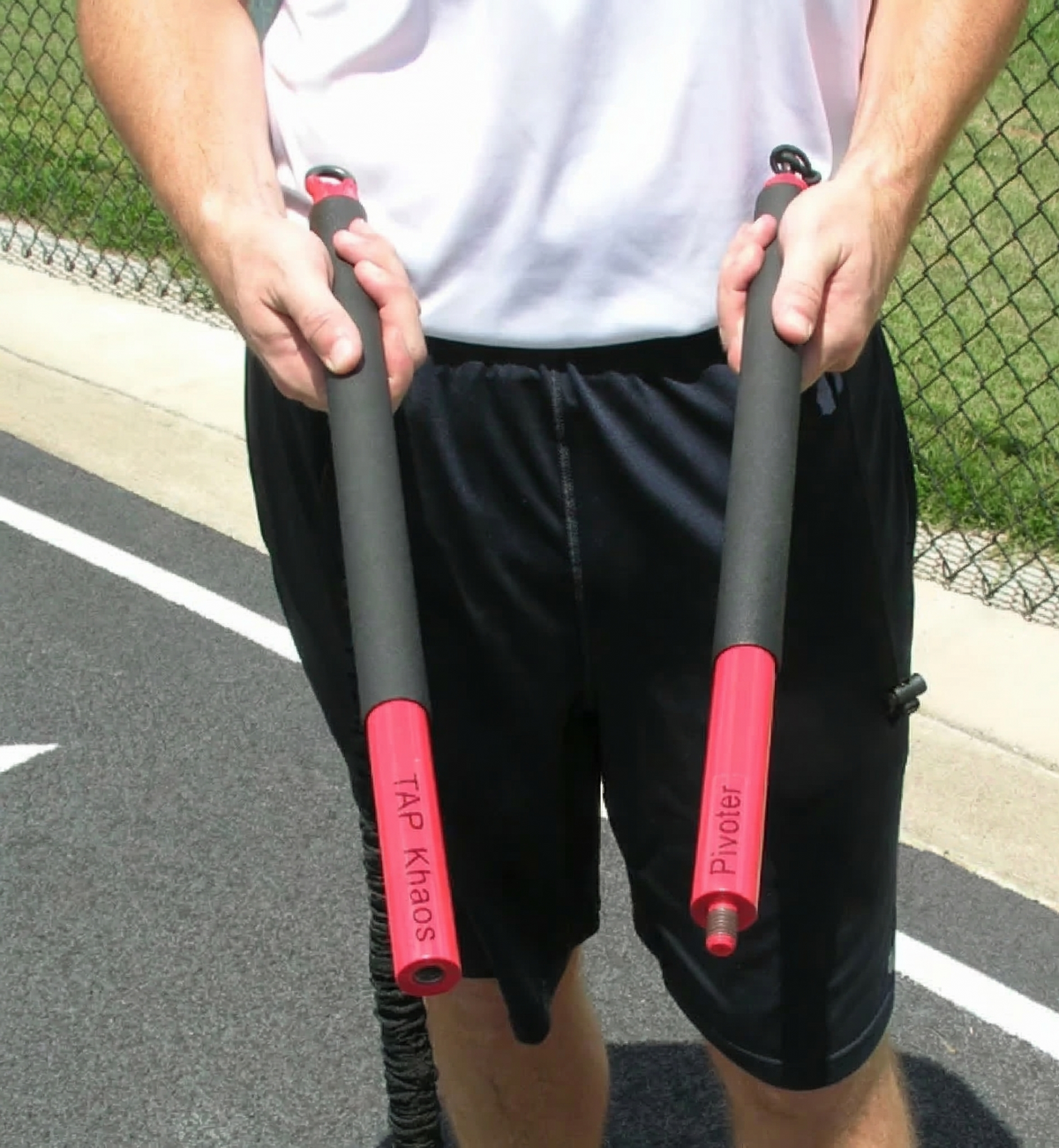 Athlete storing the KHAOS Pivoter 2-piece industrial-grade bar in its carrying case, highlighting the portable hardware design for lead-side stabilization and kinetic chain organization.