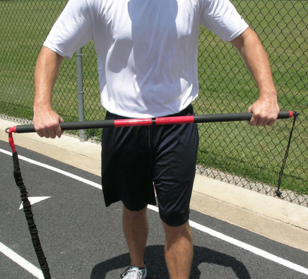 Athlete utilizing a precision-threaded stud to assemble the KHAOS Pivoter 2-piece industrial-grade bar, preparing for lead-side stabilization and kinetic chain organization.