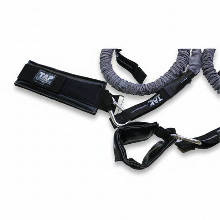 A close-up of the TAP® synthetic leather wrist cuff, designed for distal unloading. The non-porous material allows for rapid sanitization between users in high-traffic environments, while the reinforced stitching and heavy-duty steel snap-hooks provide a secure, low-friction connection for isolating the scapular stabilizers and posterior rotator cuff without grip compensation.