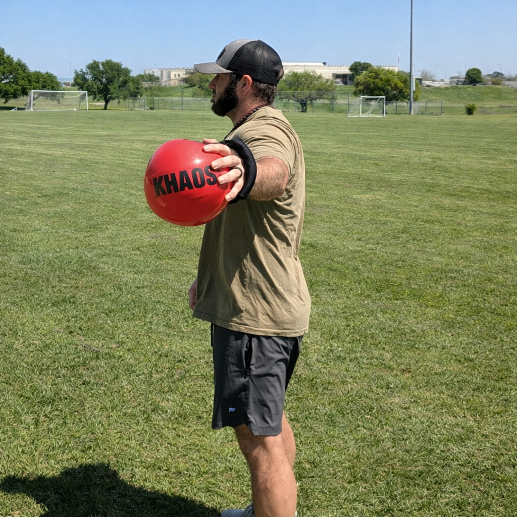 Athlete using a water-filled mini aqua for dynamic shoulder warm-ups and arm strengthening, performing perturbation exercises to activate muscles effectively.