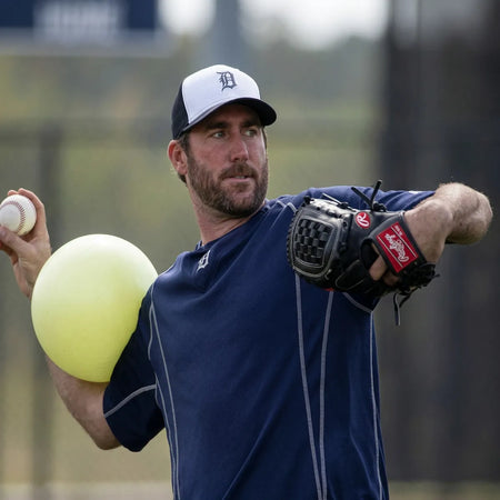 Justin Verlander using a TAP® Connection Ball® as a tactile constraint to support consistent body positioning and efficient sequencing during throwing drills.