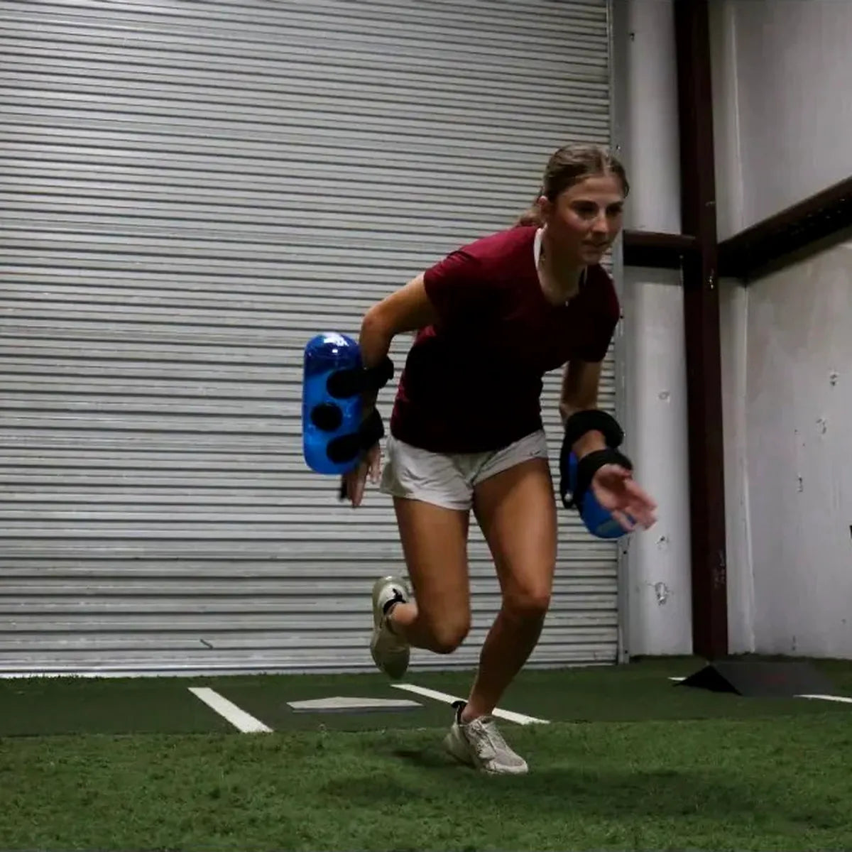 Athlete utilizing dual KHAOS® Waterboy Jr. tubes to drive rhythmic scapular stabilization and maximize force transmission through the kinetic chain via high-intensity water perturbations.