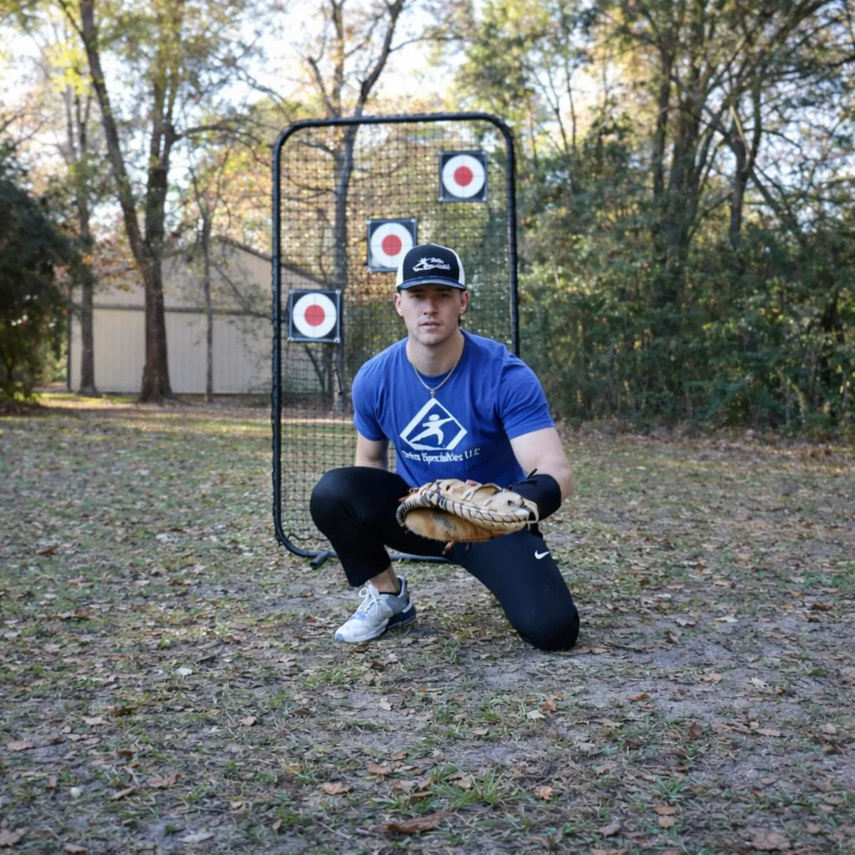 Baseball catcher wearing the TAP® Weighted Forearm Sleeve on his glove hand, using distal loading to build hand awareness and reinforce glove-side stability during receiving and transfer patterns.