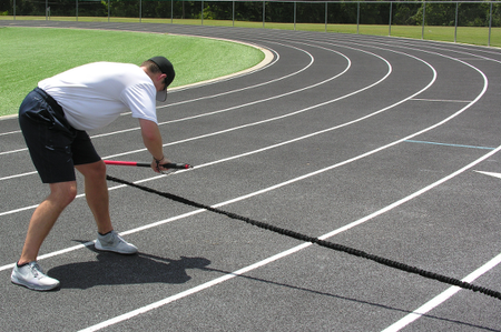 Athlete performing a bent-over row with the KHAOS® Pivoter, engaging back strength, core stability, and controlled movement during dynamic resistance training.