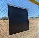 TAP Portable Plyo Mat mounted on chain link fence at baseball field for portable training setup