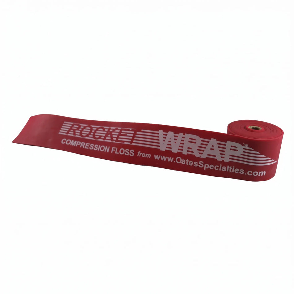 TAP® Rocket Wrap red Heavy compression floss band coiled on clean surface, highlighting heavy resistance level and durable natural latex construction for pitcher recovery.