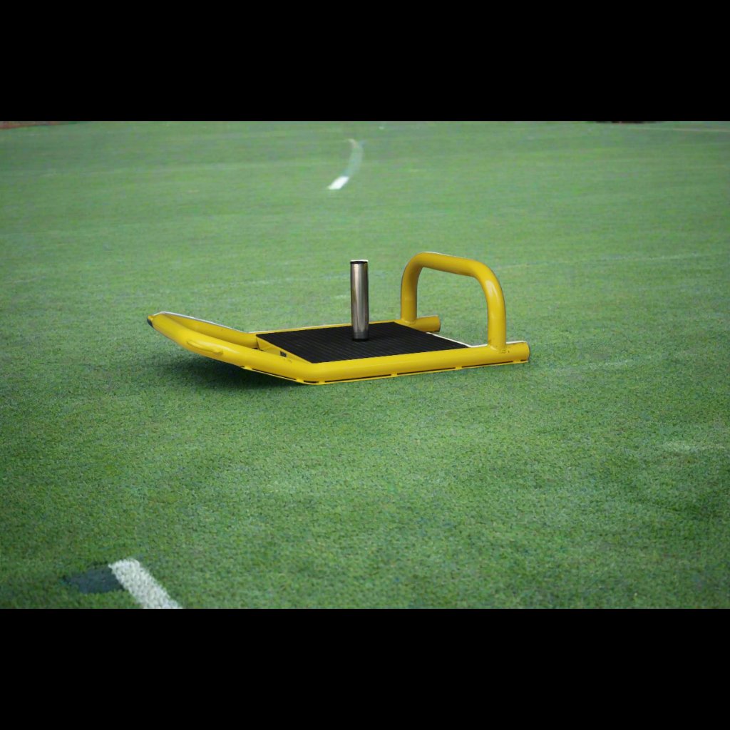 Resistance sled positioned on turf surface for product display photo.