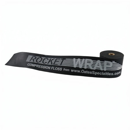 TAP® Rocket Wrap black Standard compression floss band coiled on clean surface, highlighting moderate resistance level and durable natural latex construction for pitcher recovery.