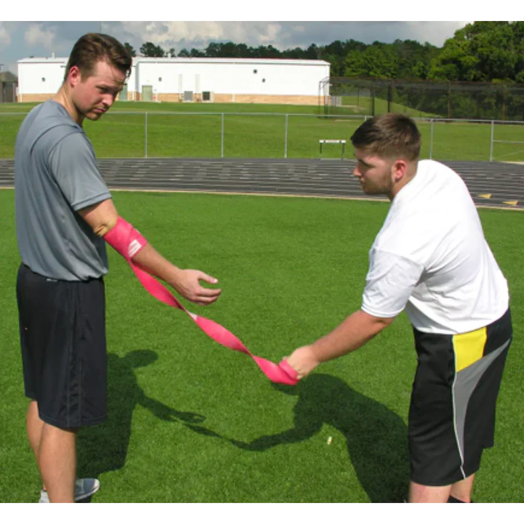 Rocket Wrap Compression Floss being removed from the arm, capturing the moment of rapid blood flow return to the targeted area to stimulate recovery.