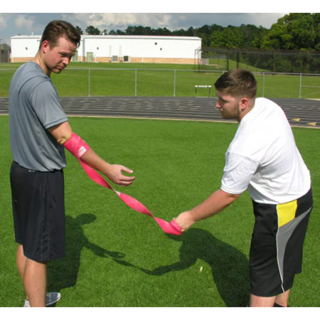 Rocket Wrap Compression Floss being removed from the arm, capturing the moment of rapid blood flow return to the targeted area to stimulate recovery.