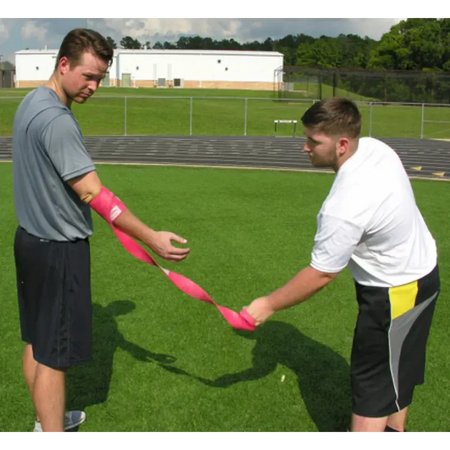 Rocket Wrap Compression Floss being removed from the arm, capturing the moment of rapid blood flow return to the targeted area to stimulate recovery.