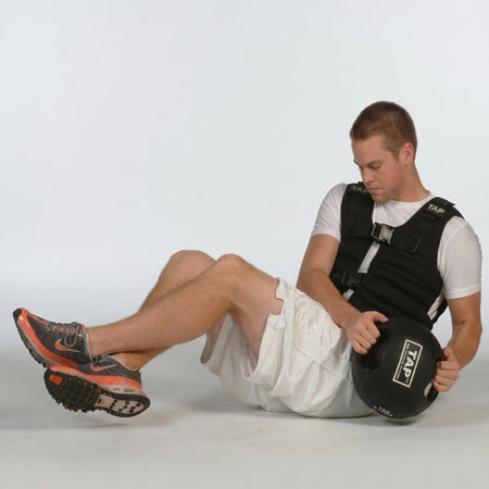 Athlete performing Russian twists with a Double Handle Medicine Ball—engaging core muscles through rotational movement for strength and stability training.